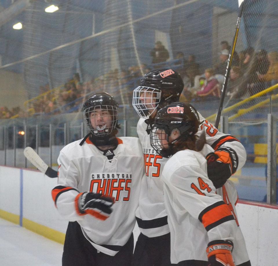 Cheboygan's Alex Clymer, middle, celebrates with teammates Noah Gingrich (5) and Warren Farver (14) after scoring the go-ahead goal in the third period against Cadillac on Tuesday.