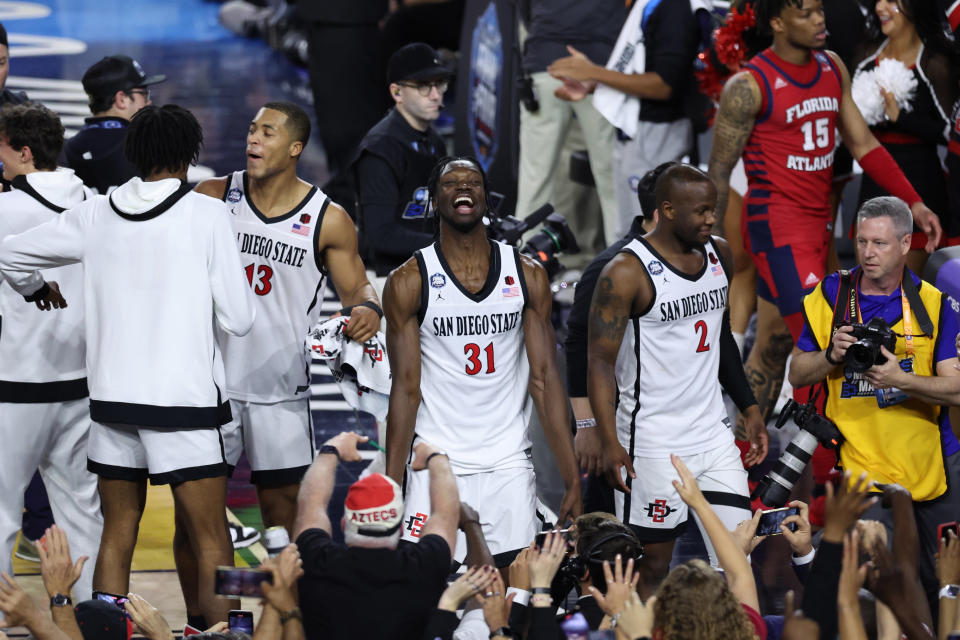Apr 1, 2023; Houston, TX, USA; San Diego State Aztecs forward Nathan Mensah (31) celebrates with fans in the stands after defeating the Florida Atlantic Owls in the semifinals of the Final Four of the 2023 NCAA Tournament at NRG Stadium. Mandatory Credit: Troy Taormina-USA TODAY Sports