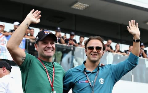 Brazilian former F1 drivers Rubens Barrichello (L) and Felipe Massa (R) wave to the crowds before the Formula One Grand Prix of Brazil at Autodromo Jose Carlos Pace on November 11, 2018 in Sao Paulo, Brazil - Credit: getty images