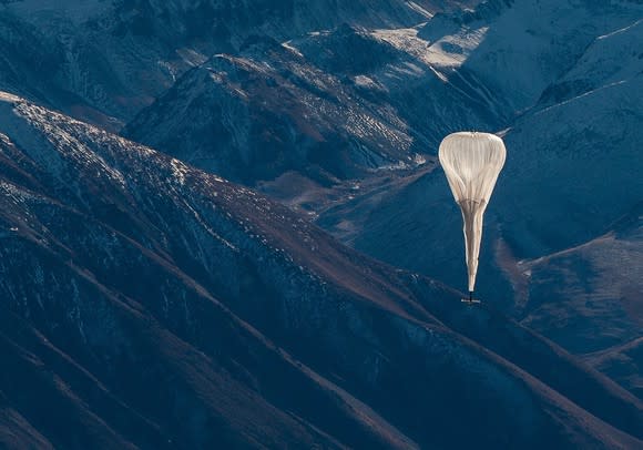 A Loon internet balloon floating over mountains