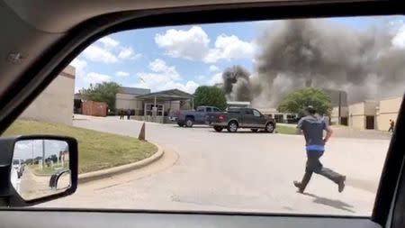 Smoke rises above the Coryell Memorial Hospital in Gatesville, Texas, U.S., June 26, 2018 in this picture obtained from social media. SUE ECKHARDT/via REUTERS