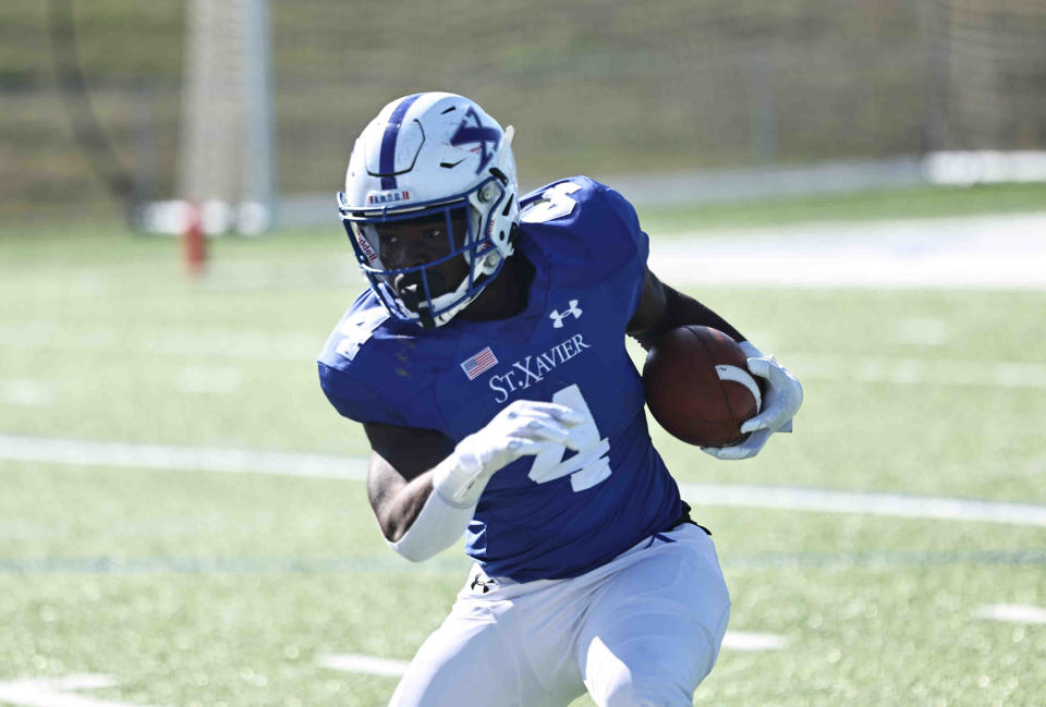 St. Xavier running back Steven Napier (4) runs the ball during a football game between St. Ignatius and St. Xavier high schools Saturday, Oct. 15, 2022.