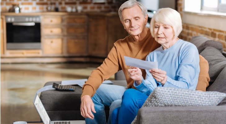 A wife and husband look over one of their Social Security benefit checks. 