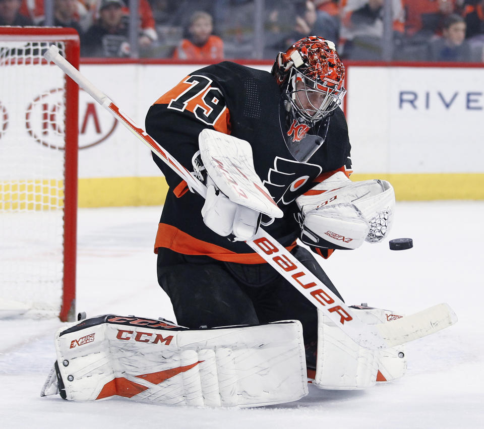 Philadelphia Flyers' Carter Hart stops a shot on goal during the first period of an NHL hockey game against the New York Rangers, Monday, Dec. 23, 2019, in Philadelphia. (AP Photo/Tom Mihalek)