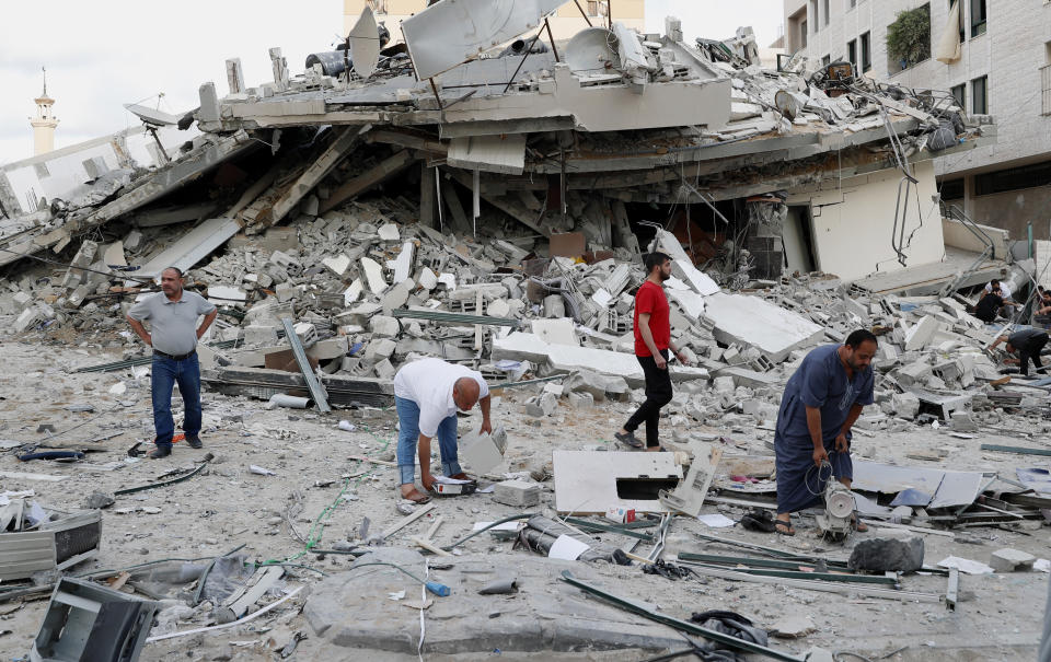 People inspect the rubble of destroyed residential building that was hit by an Israeli airstrike, in Gaza City, Monday, May 17, 2021. (AP Photo/Adel Hana)