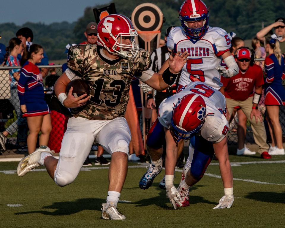 Sheridan quarterback Caden Sheridan scrambles away from Licking Valley defender during the Generals' 33-14 victory at Paul Culver Stadium in the season opener on Friday, Aug. 18, 2023.