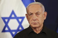 FILE - Israeli Prime Minister Benjamin Netanyahu attends a press conference with Defense Minister Yoav Gallant and Cabinet Minister Benny Gantz in the Kirya military base in Tel Aviv, Israel, Saturday, Oct. 28, 2023. U.S. and Mideast mediators appeared optimistic in recent days that they are closing in on a deal for a two-month cease-fire in Gaza and the release of over 100 hostages held by Hamas. But on Tuesday, Israeli Prime Minister Netanyahu rejected the militant group's two main demands — that Israel withdraw its forces from Gaza and release thousands of Palestinian prisoners — indicating that the gap between the two sides remains wide. (Abir Sultan/Pool Photo via AP, File)