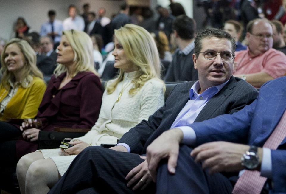 Washington Redskins owner Daniel Snyder, right, is seated with, from left to right, Sherry Gruden, wife of new head coach Jay Gruden; Kiersten Allen, wife of Executive Vice President and General Manager Bruce Allen; and his spouse Tanya Snyder, as they attend a news conference to introduce Jay Gruden as the new Redskins head coach at the Redskins Park in Ashburn, Va., Thursday, Jan. 9, 2014. Jay Gruden is Redskin’s eighth head coach since Daniel Snyder purchased the franchise in 1999. (AP Photo/Manuel Balce Ceneta)