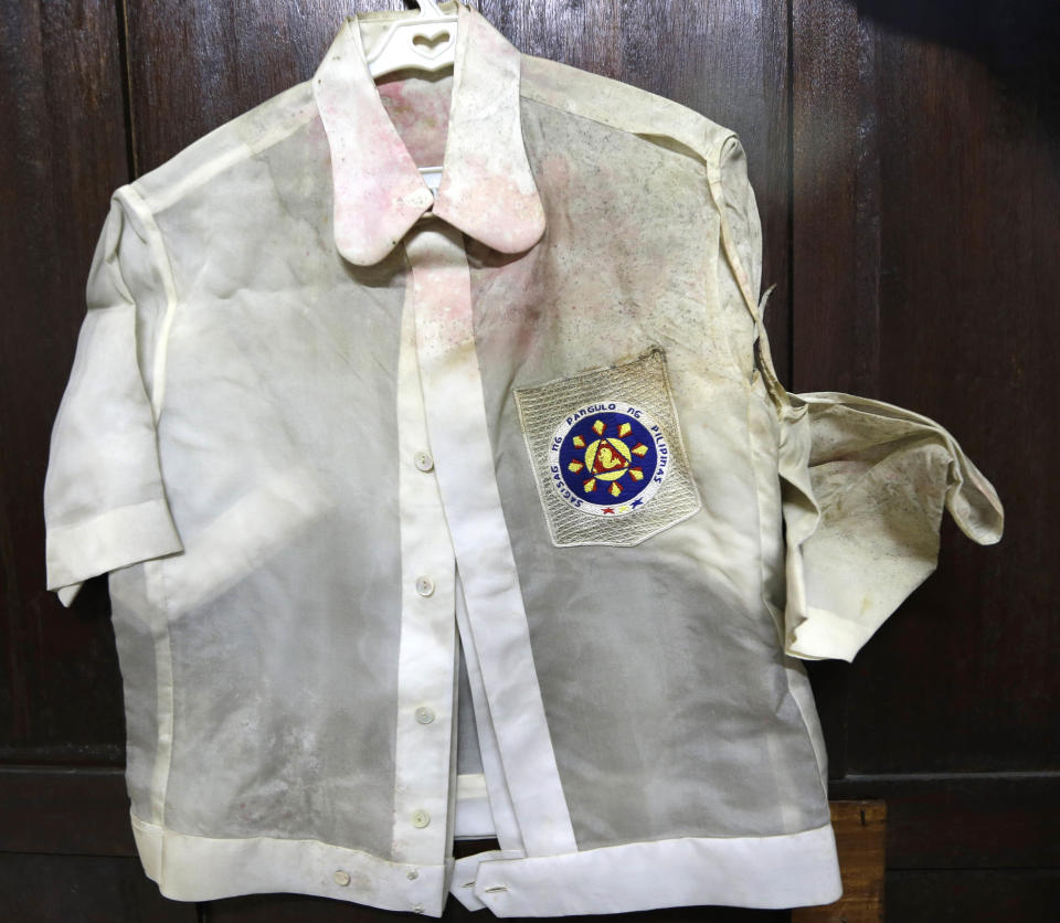 In this photo taken Sept. 19, 2012, native Filipino attire called "Barongs" which had been often worn in public during the two-decade rule of the late strongman Ferdinand Marcos, is revealed from a section of the National Museum in Manila, Philippines. Termites, storms and government neglect have damaged hundreds of pieces of Marcos' "barongs" as well as former first lady Imelda Marcos's legendary stash of shoes, expensive gowns and other vanity possessions, which were left to oblivion after she and her dictator husband were driven to U.S. exile by a 1986 popular revolt. (AP Photo/Bullit Marquez)