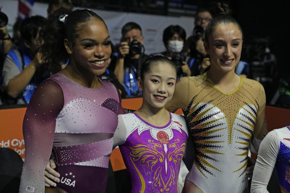 Gold medallist China's Wei Xiaoyuan, center, silver medal winner Shilese Jones of the U.S., left, and bronze winner Belgium's Nina Derwael celebrate after competing in the uneven bars finals during the Artistic Gymnastics World Championships at M&S Bank Arena in Liverpool, England, Saturday, Nov. 5, 2022. (AP Photo/Thanassis Stavrakis)