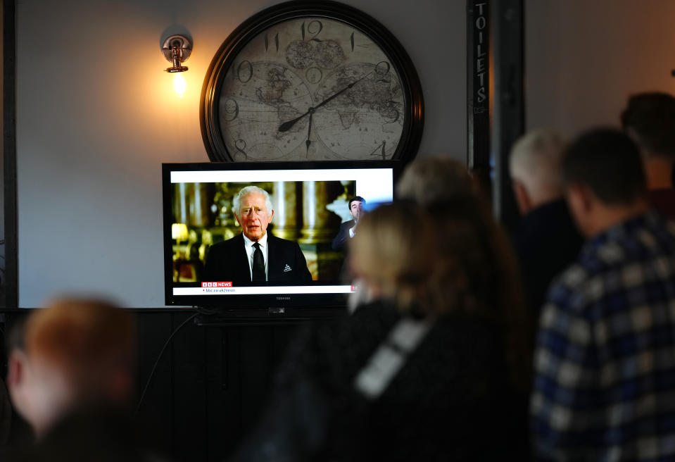 Members of the public in The Prince Harry Pub, Windsor, watching a broadcast of King Charles III first address to the nation. (PA)