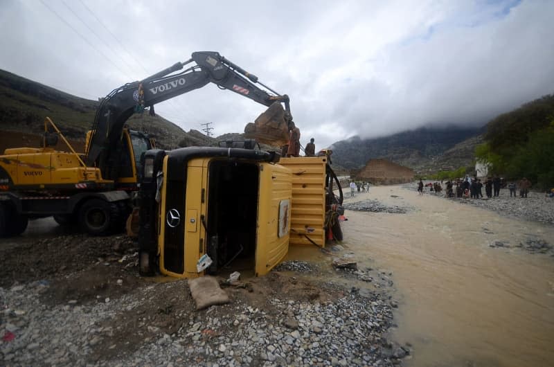 Rescue workers upright a truck that fell into the water in the Khyber district after a heavy rains. Hussain Ali/ZUMA Press Wire/dpa