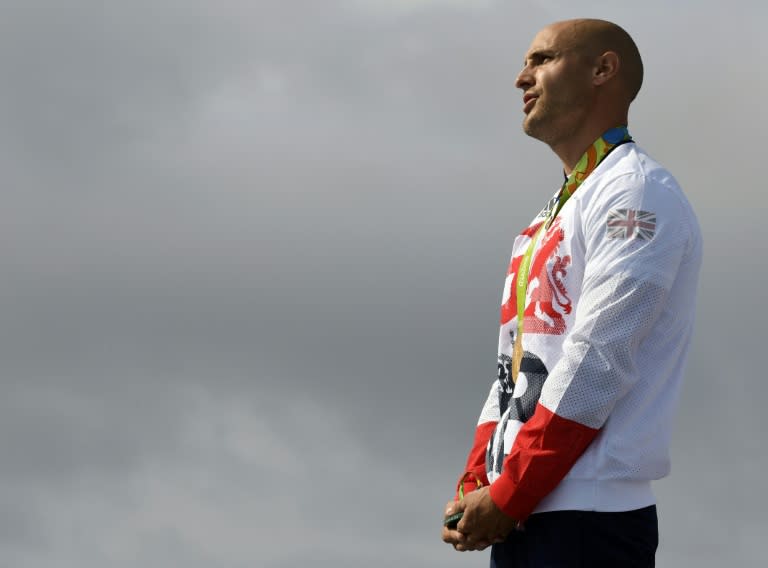 Britain's Liam Heath celebrates on the podium of the Men's Kayak Single 200m final during the Rio 2016 Olympic Games