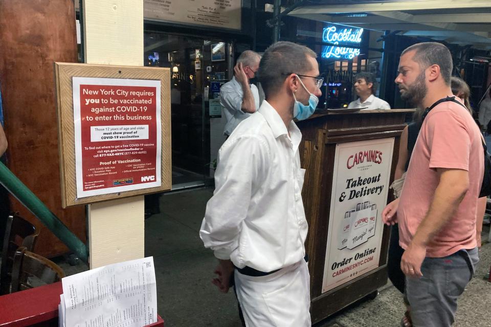 A sign informs customers they must show proof of vaccination against COVID-19 to dine indoors at Carmine's Italian restaurant on the Upper West Side of Manhattan in New York City on Tuesday, Aug. 31, 2021.