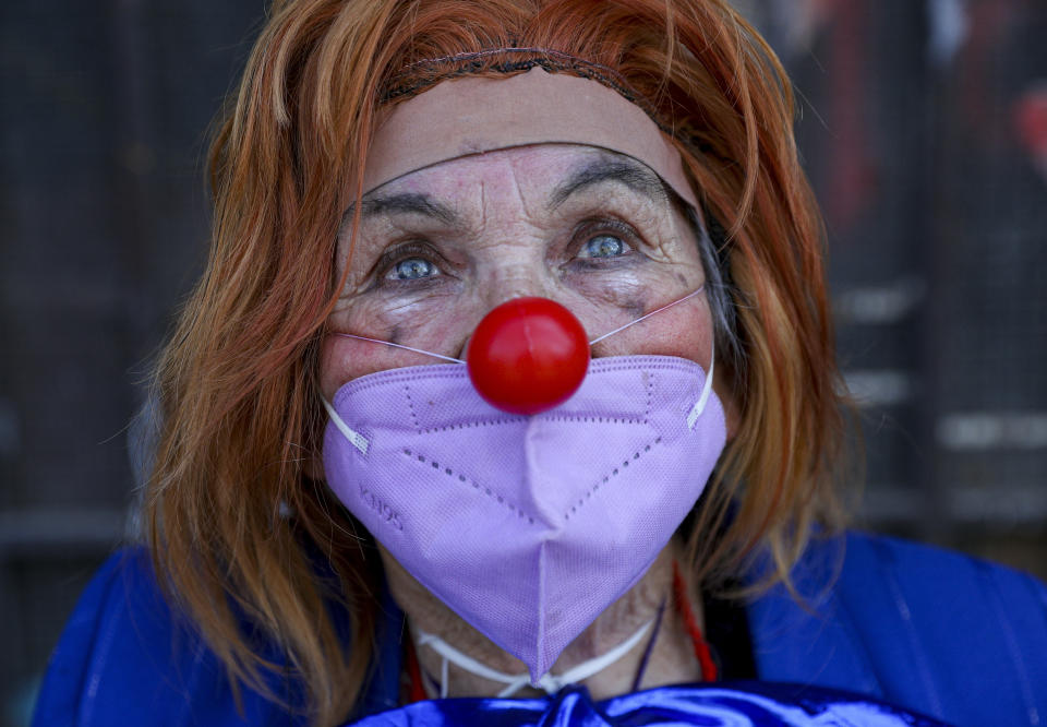 Performer Dionisia Valle, 82, dressed as a clown, poses for a photo during the National Circus Day celebration in Santiago, Chile, Saturday, Sept. 4, 2021, amid the new coronavirus pandemic. Chile’s Culture Minister set the stage for the first circus performances with a ringside public since the beginning of the pandemic quarantine measures as the South American country looks to fully roll back almost all COVID-19 related restrictions (AP Photo/Esteban Felix)