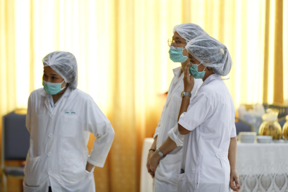 Hospital workers watch a press conference at their hospital where the rescued boys are recovering. Source: AP