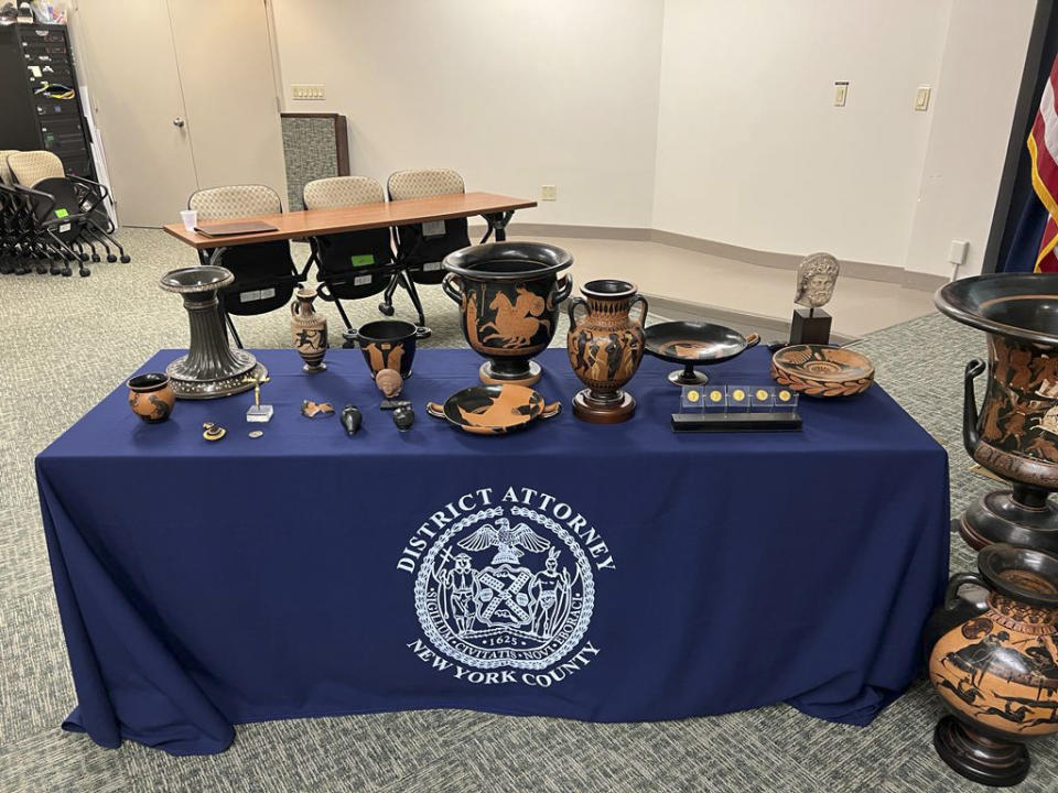 In this picture made available by the Italian Carabinieri, paramilitary police, Friday, Aug. 11, 2023, some of the 266 266 antiquities returned from the United States to Italy are displayed during a handing over ceremony t the offices of the Manhattan district attorney. Italy on Friday celebrated the return of 266 antiquities from the United States, including Etruscan vases and ancient Roman coins and mosaics worth tens of millions of euros (dollars), that were looted from Italian soil and sold to U.S. museums and private collectors. (Italian Carabinieri Via AP)