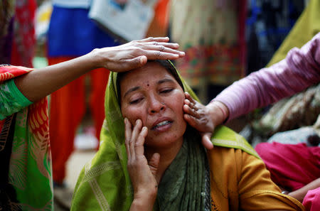 A relative of Yogesh Raj, a Hindu activist, cries after Raj got arrested for leading the protests in which two people died on Monday, in Nayabans village in Bulandshahr district, Uttar Pradesh, India December 5, 2018. REUTERS/Adnan Abidi