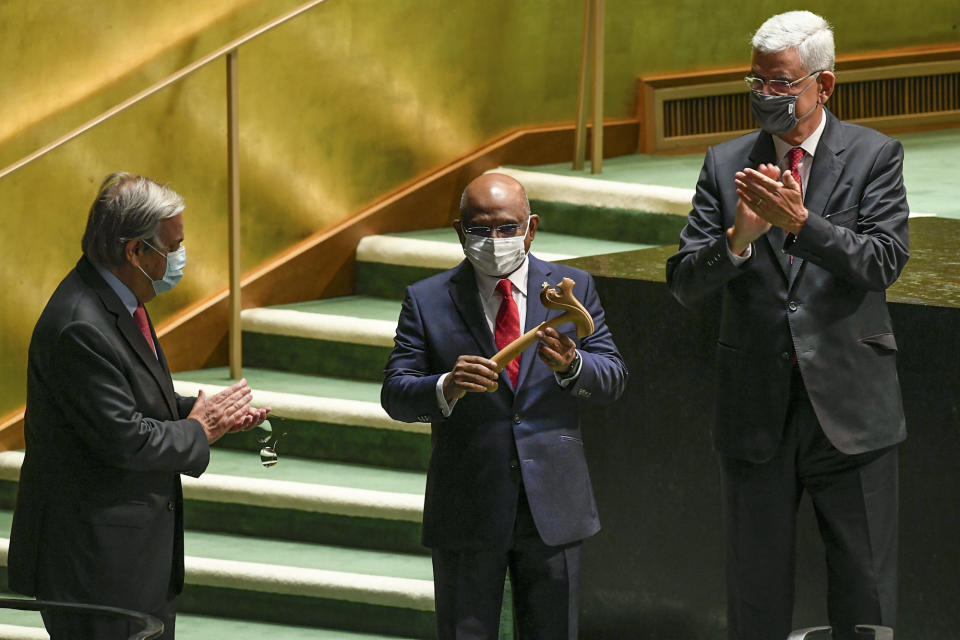 FILE - In this Tuesday, Tuesday, Sept. 14, 2021, file photo provided by United Nations, U.N. Secretary-General António Guterres, left, and Volkan Bozkir, right, president of the 75th session of the United Nations General Assembly, applaud as Abdulla Shahid, center, receives the gavel as the new president of the 76th session of the UNGA at U.N. headquarters. World leaders will have to be vaccinated against the coronavirus to speak at the U.N. General Assembly's big meeting next week, the assembly leader and New York City officials said this week, prompting swift objections from at least one nation.(Evan Schneider/United Nations Photo via AP, File)