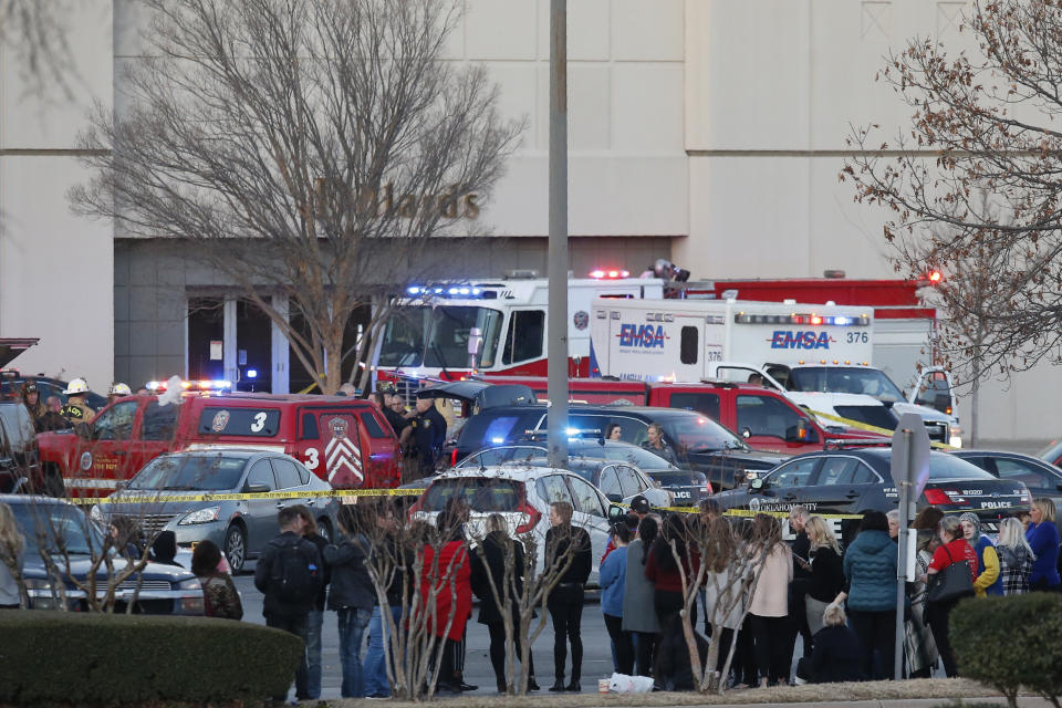 Bystanders watch as police clear Penn Square Mall following a shooting Thursday, Dec. 19, 2019, in Oklahoma City. One person was shot at the mall during what police are calling a disturbance involving two people. (AP Photo/Sue Ogrocki)