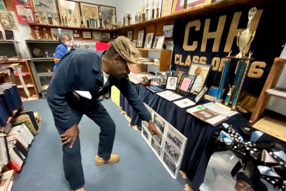 Carver-Hill High School alumni David Wheeler points himself out in a class picture. Wheeler's class, the last one to graduate from the school before it closed, raised money to buy the school blue velvet curtains for the stage. The velvet stage material is now displayed at the Carver-Hill Museum along with photos and other artifacts.