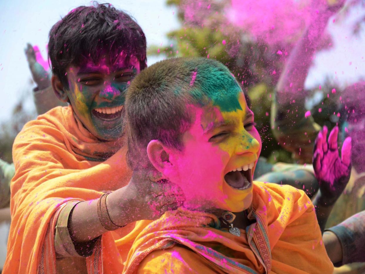 Students celebrate the festival of Holi in Jabalpur, in the Indian state of Madhya Pradesh (21 March 2019): UMA SHANKAR MISHRA/AFP via Getty Images