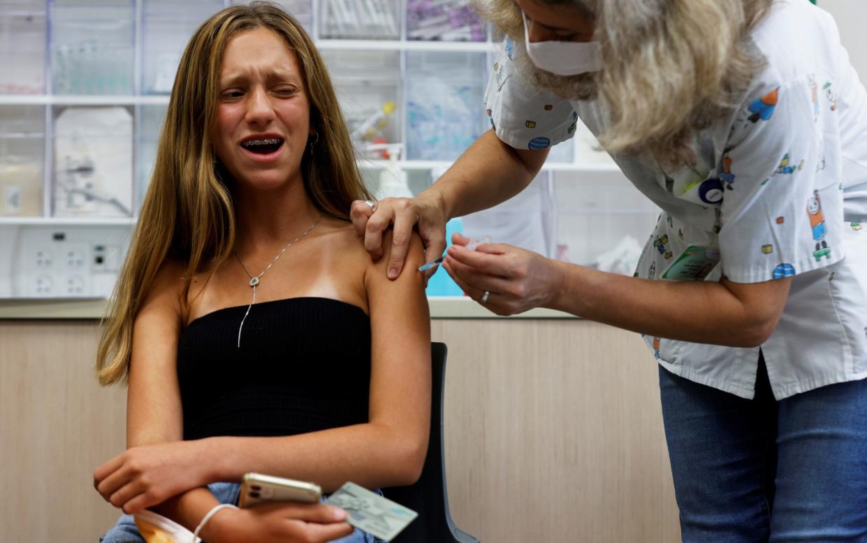 Israeli teenagers are being vaccinated following Covid outbreaks in schools - Reuters