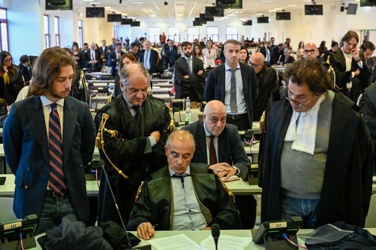 Officials listen as judges read the verdicts  (AP)