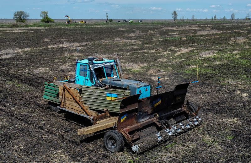 Remote controlled demining machine made of tractor and armoured plates from destroyed Russian military vehicles is seen in a field near the village of Hrakove