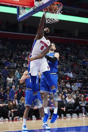 Mar 28, 2019; Detroit, MI, USA; Detroit Pistons center Andre Drummond (0) dunks against Orlando Magic center Nikola Vucevic (9) in the second half at Little Caesars Arena. Mandatory Credit: Rick Osentoski-USA TODAY Sports