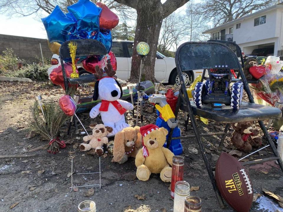 Dozens of candles, toys and other memorabilia fill the area where Keith Jhay “KJ” Frierson was shot and killed on Dec. 30 in Hillsdale Oaks condo community of Foothill Farms. The boy accused of firing the gun will not be charged but his father, who left the gun in a car, faces multiple charges.