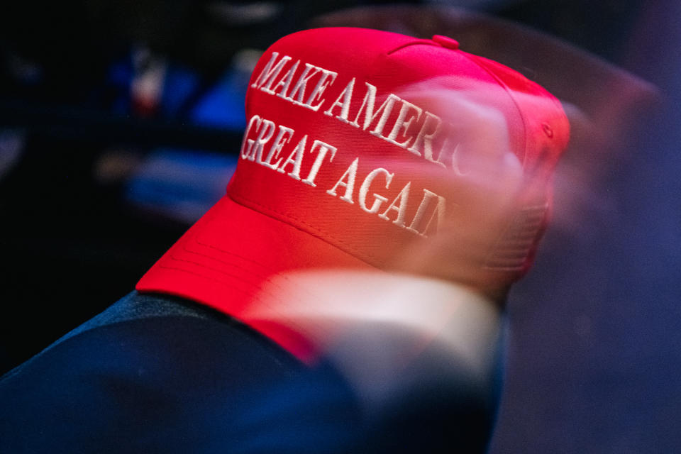 PHOENIX, ARIZONA - JULY 24: A 'Make America Great Again baseball cap rests on the knee of a person at the Rally To Protect Our Elections conference on July 24, 2021 in Phoenix, Arizona. The Phoenix-based political organization Turning Point Action hosted former President Donald Trump alongside GOP Arizona candidates who have begun candidacy for government elected roles. (Photo by Brandon Bell/Getty Images)