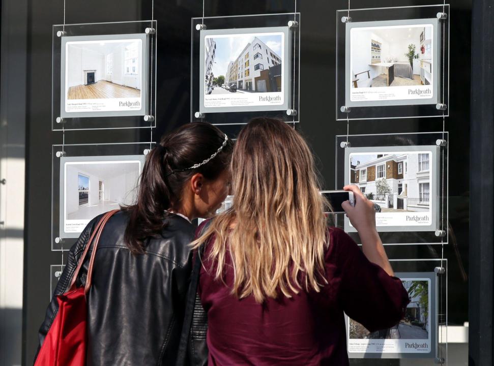 File photo dated 08/06/2016 of a couple of women studying the house price signs in an estate agents window, in Kentish Town, London. Homes in London took twice as long as properties in Scotland to sell on average last year, according to a website. In 2023, the average sale took 34 days - from the property first being launched to the market to a sale being agreed, subject to contract - Zoopla said. Issue date: Friday February 16, 2024.