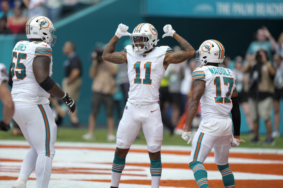 Miami Dolphins wide receiver Cedrick Wilson Jr. (11) celebrates scoring a touchdown during the first half of an NFL football game against the New England Patriots, Sunday, Oct. 29, 2023, in Miami Gardens, Fla. (AP Photo/Wilfredo Lee)