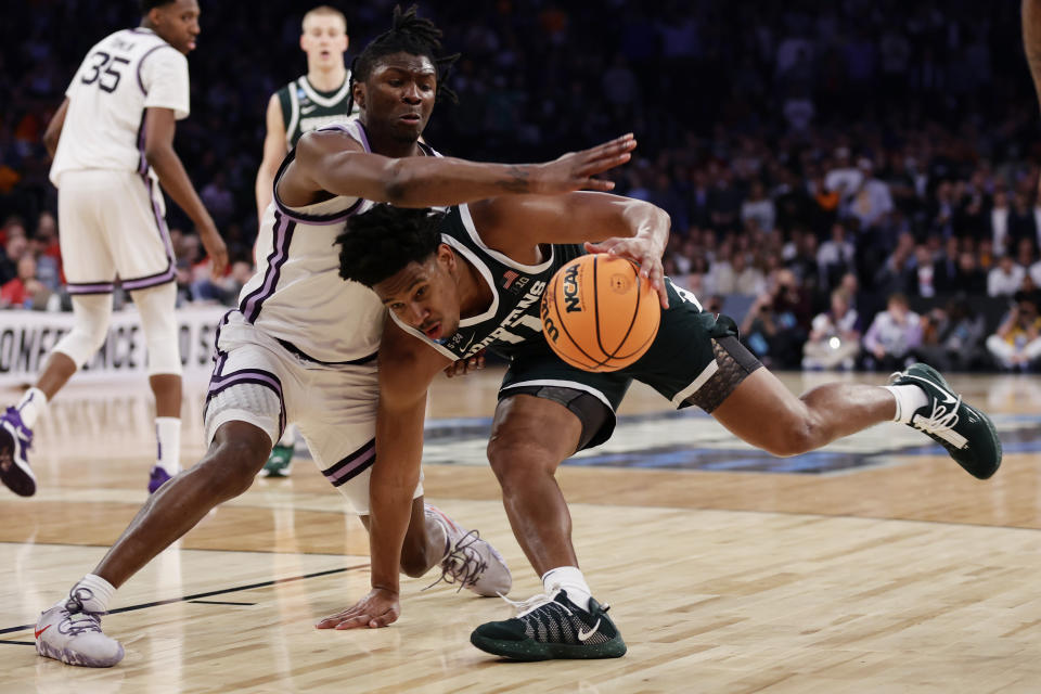 Kansas State guard Cam Carter (5) reaches in on Michigan State guard A.J. Hoggard (11) during overtime of a Sweet 16 college basketball game in the East Regional of the NCAA tournament at Madison Square Garden, Thursday, March 23, 2023, in New York. (AP Photo/Adam Hunger)