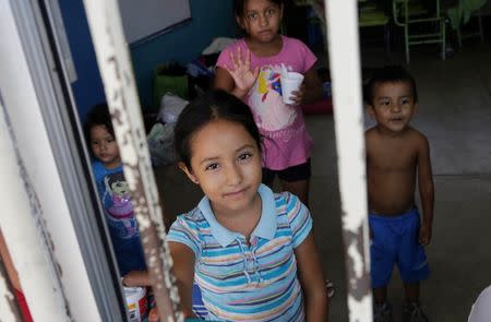 Children who were evacuated look on inside a school used as a shelter in Cabo San Lucas, after Hurricane Odile hit in Baja California September 18, 2014. REUTERS/Henry Romero