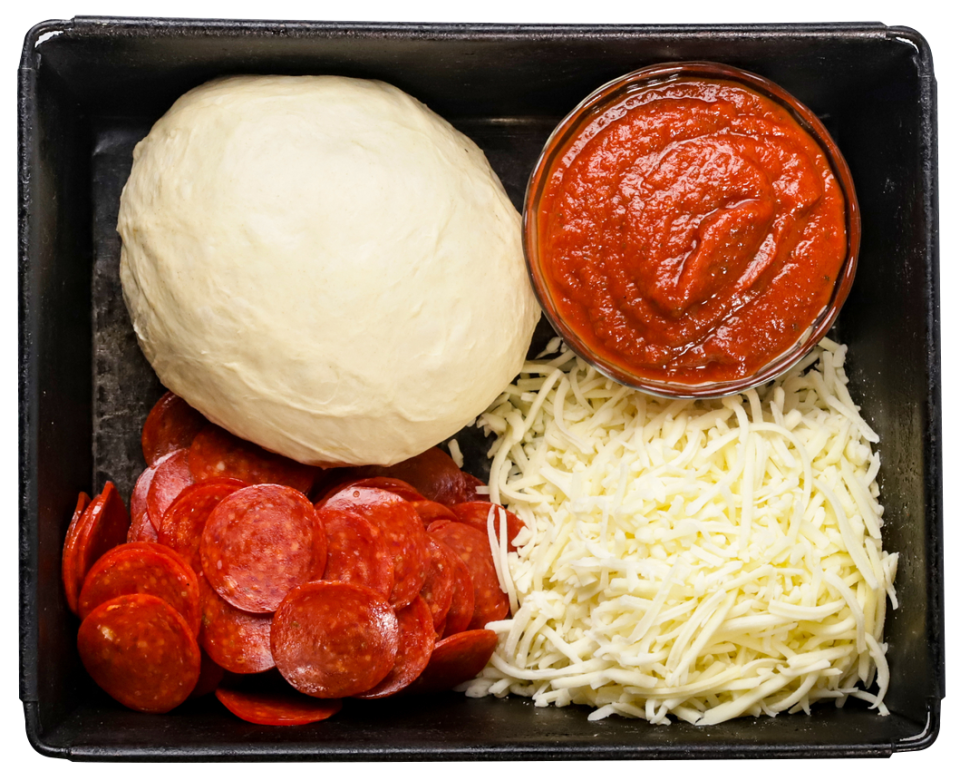 The ingredients you need to make a Detroit-style pizza: asquare deep dish pizza pan, pepperoni, mozzarella cheese, pizza sauce and, of course, the dough.