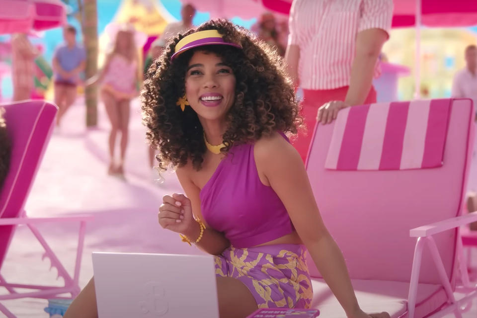 <p>Alexandra Shipp looks just like a '90s Barbie doll with seashell earrings and a purple visor. And seeing as her Barbie is a "celebrated author," she's fittingly typing away at her laptop at the beach. </p>