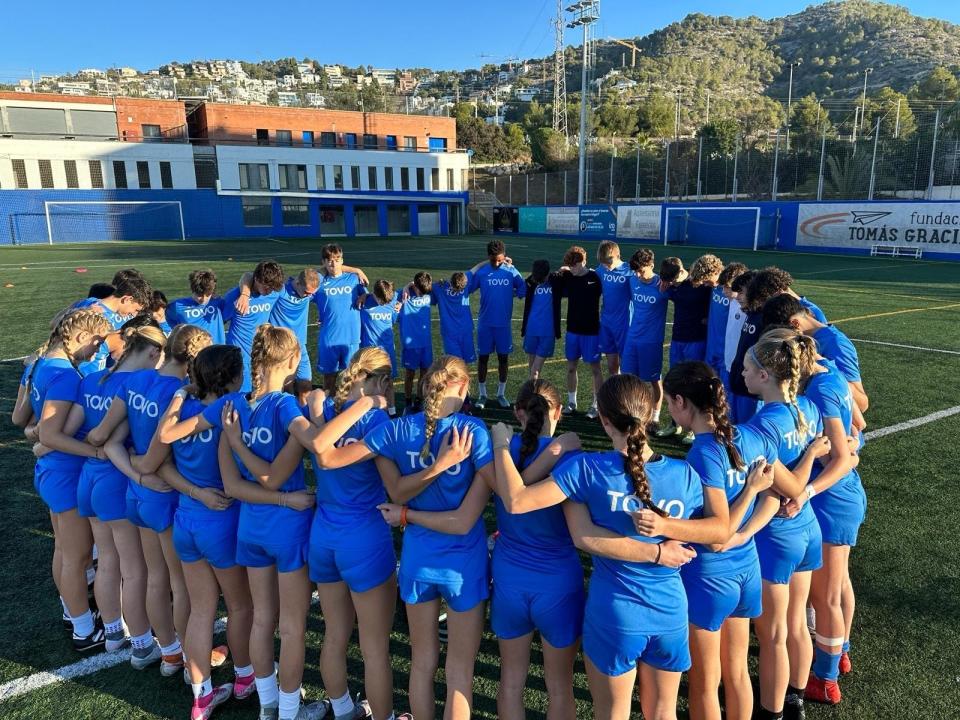 Leah Schamberg and members of her training group, including boys, huddle after practice at the TOVO Academy in Spain.