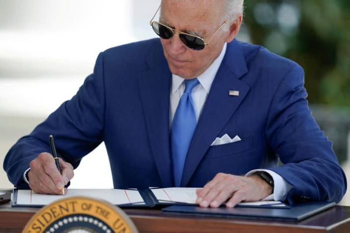 FILE PHOTO: U.S President Joe Biden signs two bills aimed at combating fraud in the COVID-19 small business relief programs in Washington