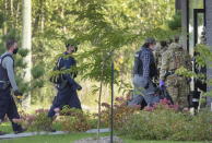 RCMP officers prepare to enter an apartment complex in connection with the mailing of ricin to President Trump Monday, Sept. 21, 2020 in St. Hubert, Canada. (Ryan Remiorz/The Canadian Press via AP)