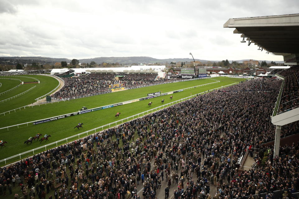 FILE - In this Wednesday March 11, 2020 file photo, a general view from the Grand Stand as Envoi Allen ridden by Davy Russell wins the Ballymore Novices' Hurdle day two of the Cheltenham Horse Racing Festival at Cheltenham Racecourse, England. More than 100,000 people have died in the United Kingdom after contracting the coronavirus. That's according to government figures released Tuesday Jan. 26, 2021. Britain is the fifth country in the world to pass that mark, after the United States, Brazil, India and Mexico, and by far the smallest. The U.S. has recorded more than 400,000 COVID-19 deaths, the world's highest total, but its population of about 330 million is about five times Britain's. (Tim Goode/PA via AP, File)