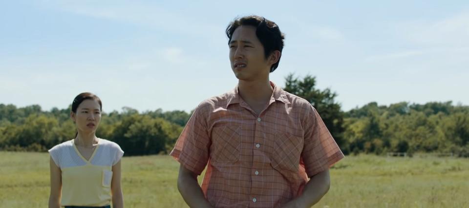 Jacob and Monica standing in a grassy field in "Minari"