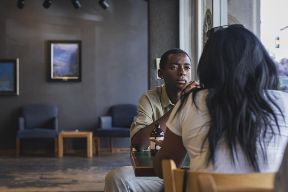 Two people sitting together at a cafe talking