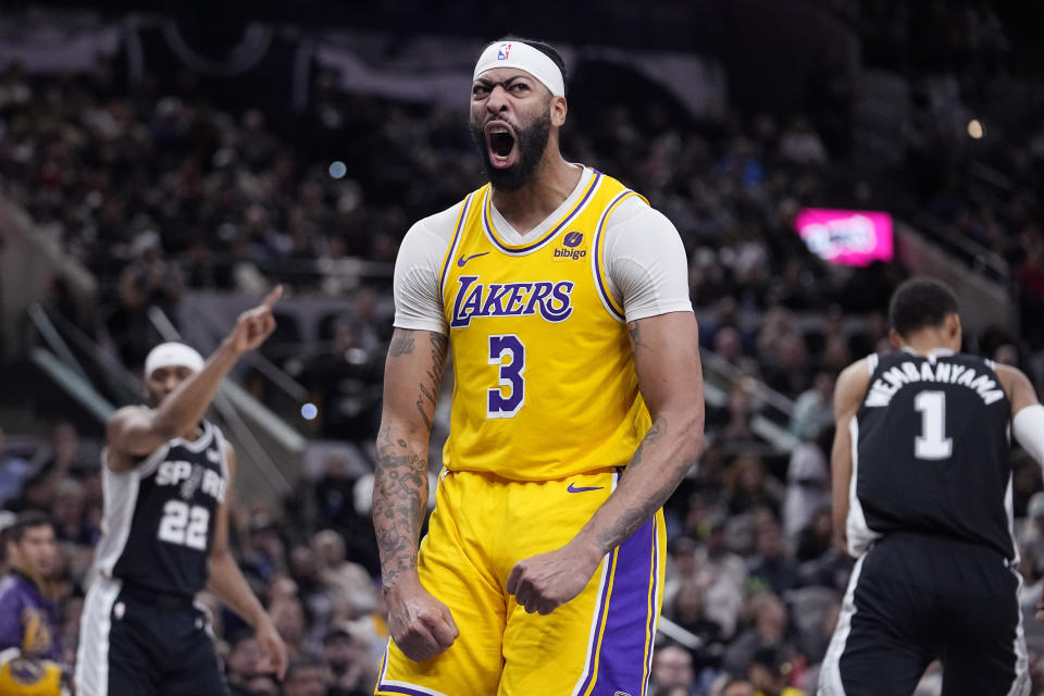 Los Angeles Lakers forward Anthony Davis (3) reacts after scoring over San Antonio Spurs center Victor Wembanyama (1) during the first half of an NBA basketball game in San Antonio, Wednesday, Dec. 13, 2023. (AP Photo/Eric Gay)