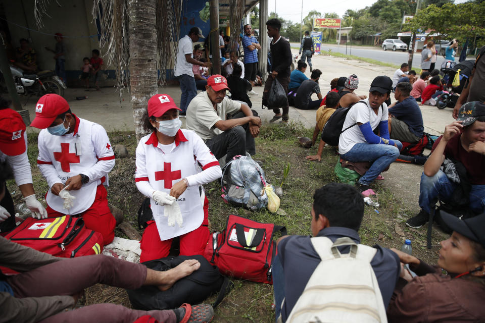 Guatemalan Red Cross paramedics attends Honduran migrants before they are deported, in Morales, Guatemala, Thursday, Jan. 16, 2020. Less-organized migrants, tighter immigration control by Guatemalan authorities and the presence of U.S. advisers have reduced the likelihood that the hundreds of migrants who departed Honduras will form anything like the cohesive procession the term “caravan” now conjures. (AP Photo/Moises Castillo)