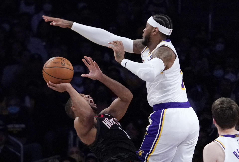 Houston Rockets guard Eric Gordon, left, shoots as Los Angeles Lakers forward Carmelo Anthony defends during the first half of an NBA basketball game Sunday, Oct. 31, 2021, in Los Angeles. (AP Photo/Mark J. Terrill)