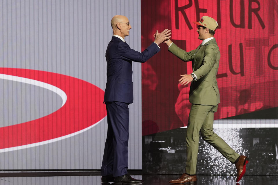 Reed Sheppard, right, greets NBA commissioner Adam Silver after being selected third overall by the Houston Rockets during they first round of the NBA basketball draft, Wednesday, June 26, 2024, in New York. (AP Photo/Julia Nikhinson)