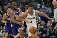 San Antonio Spurs forward Keldon Johnson (3) drives past Phoenix Suns guard Chris Paul (3) during the first half of an NBA basketball game, Monday, Jan. 17, 2022, in San Antonio. (AP Photo/Eric Gay)