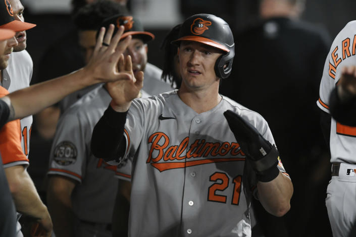 Baltimore Orioles' Austin Hays (21) is congratulated in the dugout after scoring on an Adley Rutschman double during the sixth inning of the team's baseball game against the Chicago White Sox on Thursday, June 23, 2022, in Chicago. (AP Photo/Paul Beaty)